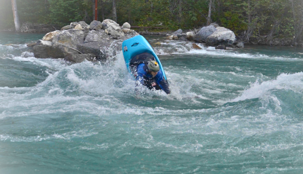 Jordy Munro performing the macho move in a freestyle kayak on the Kananaskis River in Alberta